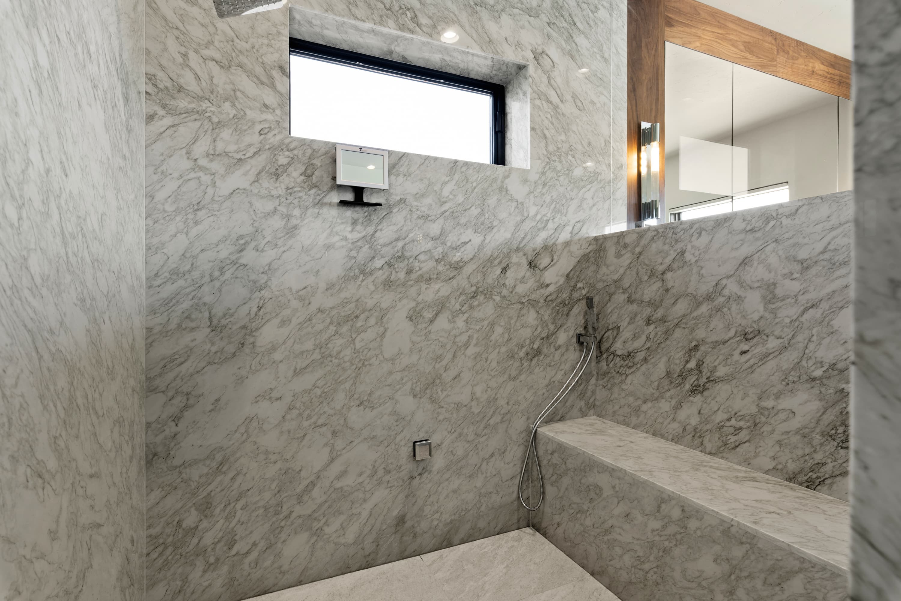 All-marble shower room with stone bench