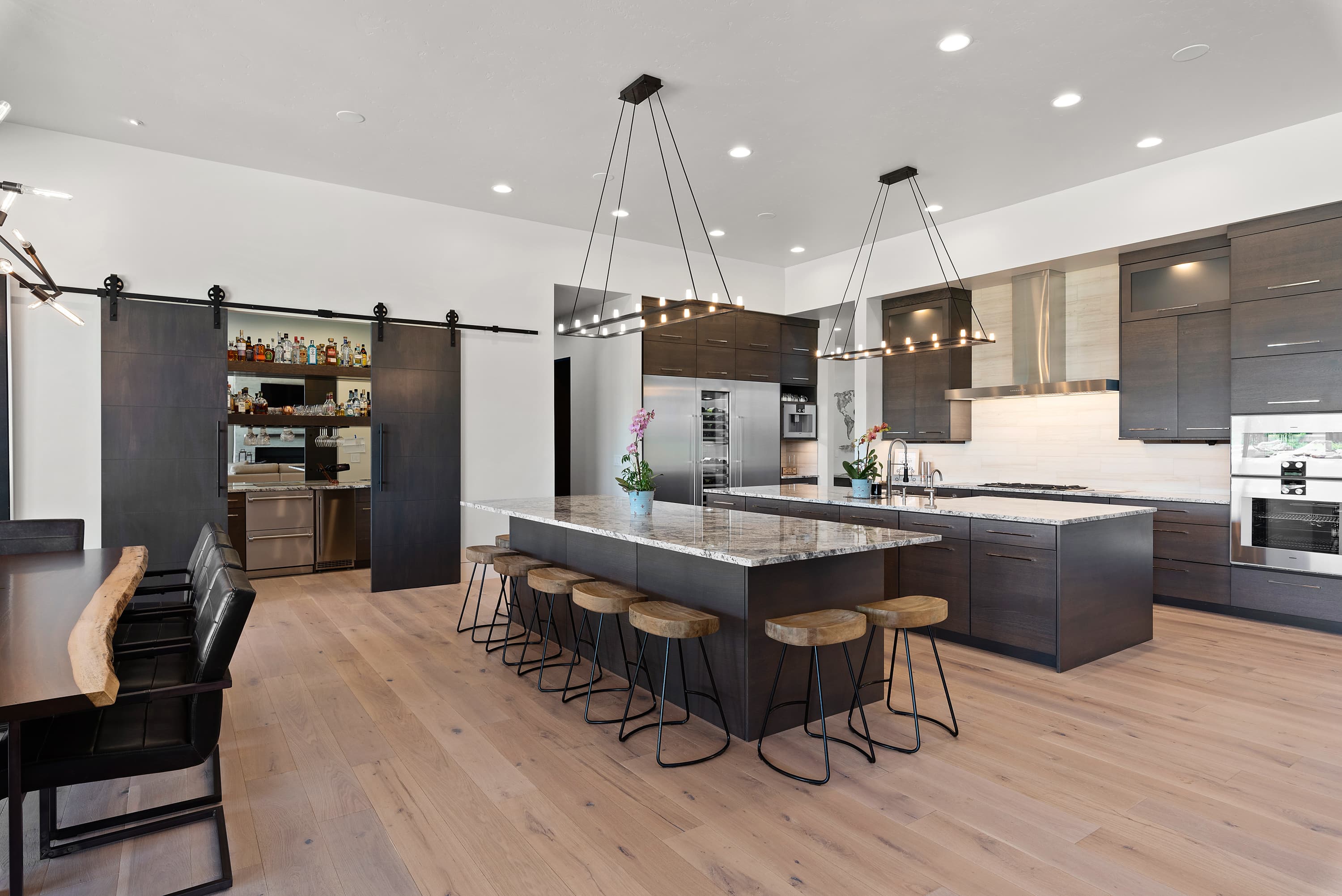 Large marble island with white veining in modern kitchen — Superior Stone Boise