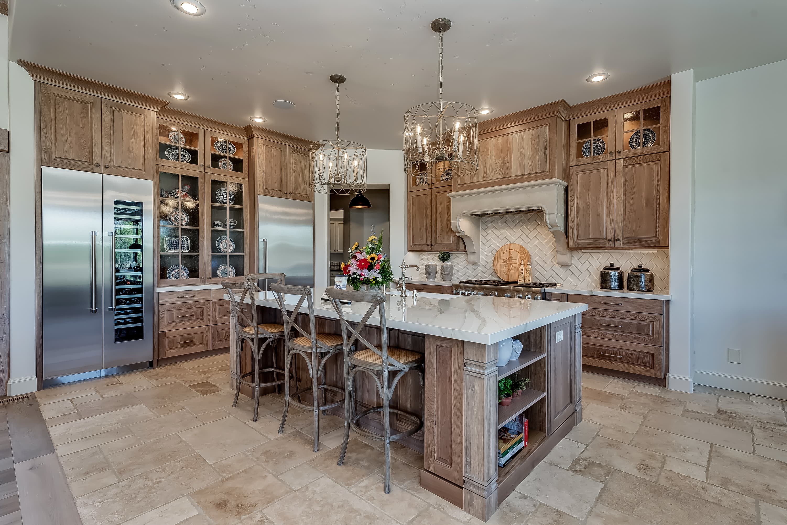 White quartzite kitchen island with warm wood cabinetry — Superior Stone Boise