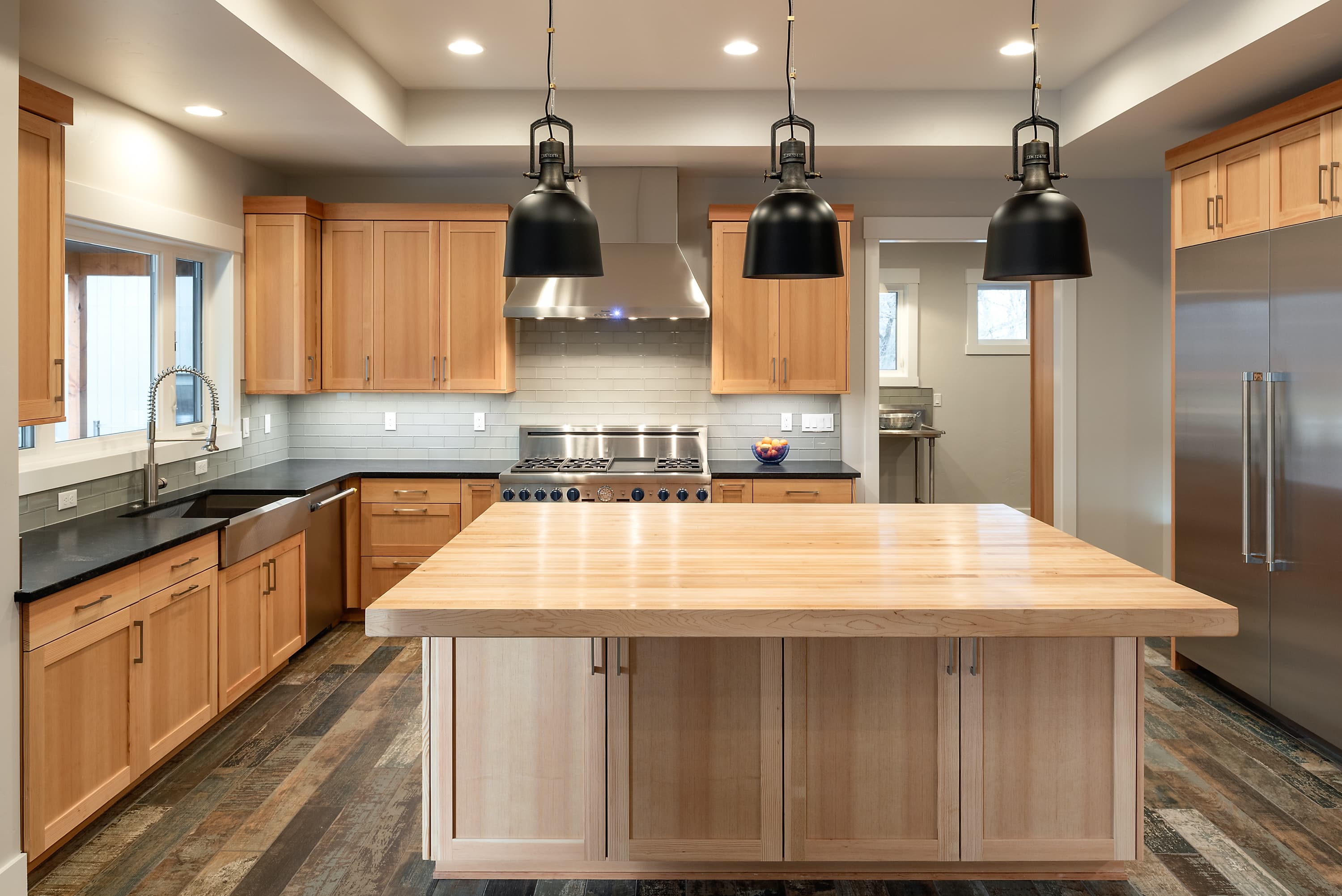 Open kitchen with large quartz island and bar seating — Superior Stone Boise
